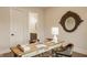Bright home office with a wooden desk, stylish chairs, and decorous round mirror at 8092 Abington Way, Zionsville, IN 46077