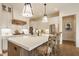 Gourmet kitchen with large island, pendant lighting, stainless appliances, and white cabinets at 8092 Abington Way, Zionsville, IN 46077