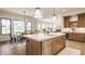 Stylish kitchen with an island, stainless steel dishwasher and open views to a dining area at 8092 Abington Way, Zionsville, IN 46077