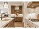 This is a kitchen area featuring custom cabinetry, a beverage center, and a view into the living room at 8092 Abington Way, Zionsville, IN 46077