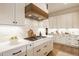 Modern kitchen with a kitchen island, pendant lights, and open views to the dining area at 8092 Abington Way, Zionsville, IN 46077