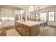 Bright kitchen with a large island, stainless steel appliances, and an open dining area at 8092 Abington Way, Zionsville, IN 46077