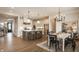 Open-concept kitchen and dining area with stainless steel appliances, island and white cabinetry at 8092 Abington Way, Zionsville, IN 46077