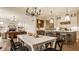 Sunlit kitchen and dining area featuring a gas fireplace and view of the kitchen island at 8092 Abington Way, Zionsville, IN 46077