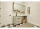 Clean laundry room featuring custom cabinets, modern fixtures, and neutral decor at 8092 Abington Way, Zionsville, IN 46077