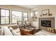 Cozy living room with a fireplace, modern seating, and views of the outdoors at 8092 Abington Way, Zionsville, IN 46077