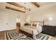 Spacious bedroom boasts decorative rug, wooden beam ceilings, stylish furniture, and lots of light at 8092 Abington Way, Zionsville, IN 46077