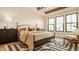 Inviting main bedroom with decorative rug, sitting area, and large windows with lots of light at 8092 Abington Way, Zionsville, IN 46077