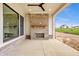 Covered patio featuring an outdoor fireplace, and views of the backyard at 8092 Abington Way, Zionsville, IN 46077