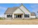 Charming rear exterior featuring white siding, a covered porch, and brick foundation at 8092 Abington Way, Zionsville, IN 46077
