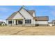 Charming rear exterior featuring white siding, a covered porch, and brick foundation at 8092 Abington Way, Zionsville, IN 46077