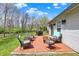 Relaxing outdoor patio with wicker furniture, a grill, and serene backyard views at 8110 Madrone Ct, Indianapolis, IN 46236