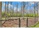Gated backyard with mature trees and access to the wooded area beyond at 8110 Madrone Ct, Indianapolis, IN 46236
