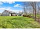 Expansive backyard featuring a play set, shed, partially fenced yard, and well-maintained lawn perfect for outdoor enjoyment at 8110 Madrone Ct, Indianapolis, IN 46236