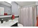 Well-lit bathroom featuring a vanity and patterned shower curtain at 8110 Madrone Ct, Indianapolis, IN 46236
