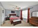 Comfortable bedroom with neutral walls, ceiling fan, and traditional furniture at 8110 Madrone Ct, Indianapolis, IN 46236