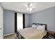 Bedroom with a ceiling fan, window with natural light, and simple decor at 8110 Madrone Ct, Indianapolis, IN 46236