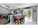 Bright dining area with an adjacent view of the living room and a sliding glass door to the backyard at 8110 Madrone Ct, Indianapolis, IN 46236