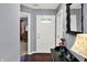 Welcoming entryway with hardwood floors, neutral paint, decorative mirror, and a view into the adjacent living spaces at 8110 Madrone Ct, Indianapolis, IN 46236
