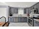 Modern kitchen featuring gray cabinetry, stainless steel appliances, tiled backsplash, and a bright, functional design at 8110 Madrone Ct, Indianapolis, IN 46236