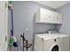 Laundry room with a washer, dryer, and plenty of cabinet space at 8110 Madrone Ct, Indianapolis, IN 46236