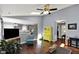 Open-concept living room with hardwood floors, an open view into the kitchen, and stylish decor at 8110 Madrone Ct, Indianapolis, IN 46236