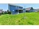 Spacious backyard featuring a covered patio, a stone firepit, and green grass at 8163 Dewberry Ln, Pendleton, IN 46064
