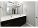 Bathroom featuring double sink vanity with dark cabinets, a large mirror, and modern lighting at 8163 Dewberry Ln, Pendleton, IN 46064