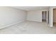 A bright bedroom featuring neutral carpeting, grey walls, and a door frame to another room at 8163 Dewberry Ln, Pendleton, IN 46064