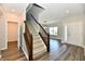 Inviting entryway with hardwood floors and staircase with wood railing at 8163 Dewberry Ln, Pendleton, IN 46064