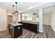 Open kitchen with granite countertops, stainless steel appliances, and wood floors at 8163 Dewberry Ln, Pendleton, IN 46064