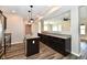 Open kitchen with granite countertops, stainless steel appliances, and wood floors at 8163 Dewberry Ln, Pendleton, IN 46064