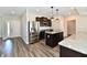 Modern kitchen featuring stainless steel appliances, granite countertops, and wood floors at 8163 Dewberry Ln, Pendleton, IN 46064