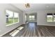 Living room featuring large windows, modern lighting, and hardwood flooring with views of the community at 8163 Dewberry Ln, Pendleton, IN 46064