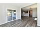 Open-concept living space with wood flooring and access to the backyard patio through sliding glass doors at 8163 Dewberry Ln, Pendleton, IN 46064