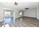 Spacious living room with wood flooring, recessed lighting, and large windows overlooking the yard at 8163 Dewberry Ln, Pendleton, IN 46064