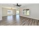 Bright living room with hardwood floors, modern lighting, and views of the community pond at 8163 Dewberry Ln, Pendleton, IN 46064