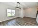 Open-concept living room with new hardwood floors and large window at 8163 Dewberry Ln, Pendleton, IN 46064