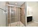 Modern bathroom featuring a glass-enclosed shower with tile surround and brushed nickel fixtures at 8163 Dewberry Ln, Pendleton, IN 46064