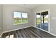 Sunroom featuring wood flooring, large window overlooking the community and glass door to patio at 8163 Dewberry Ln, Pendleton, IN 46064