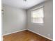 Bedroom with hardwood floors, neutral paint, and natural light from the window at 819 E Mills Ave, Indianapolis, IN 46227
