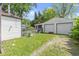 A two-car garage with an attached sunroom sits beside a fenced yard at 819 E Mills Ave, Indianapolis, IN 46227
