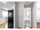 A hallway provides access to kitchen, bathroom, and hall storage at 819 E Mills Ave, Indianapolis, IN 46227