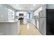 A clean and updated kitchen features stainless steel appliances and ample white cabinetry at 819 E Mills Ave, Indianapolis, IN 46227