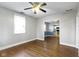 A spacious living room featuring beautiful hardwood floors and an open layout leading to the adjacent kitchen at 819 E Mills Ave, Indianapolis, IN 46227