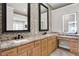 Modern bathroom with double sinks, granite counters, and decorative backsplash at 8191 S Bayview Ct, Trafalgar, IN 46181