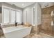 Contemporary bathroom featuring a soaking tub, separate shower, and large windows at 8191 S Bayview Ct, Trafalgar, IN 46181