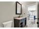 Bathroom vanity with granite countertop, black faucet, and decorative mirror at 8191 S Bayview Ct, Trafalgar, IN 46181