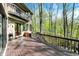 Large deck with wood railing provides a scenic view of the surrounding trees at 8191 S Bayview Ct, Trafalgar, IN 46181