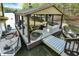 Boat dock featuring covered boat slip, jet ski lift, and a boat, perfect for lake enthusiasts at 8191 S Bayview Ct, Trafalgar, IN 46181